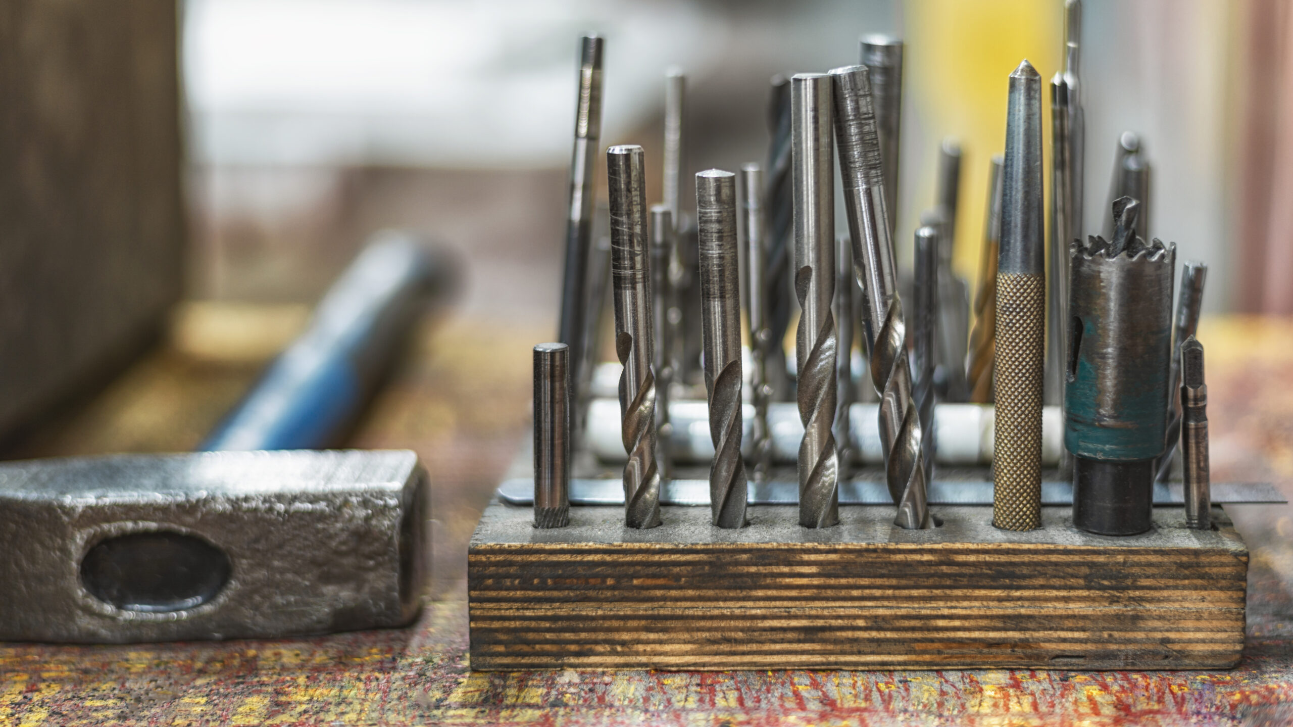 A set of drills and a hammer. The working tool of a locksmith or carpenter. A set of drills and a hammer. The working tool of a locksmith or carpenter. Selective focus.